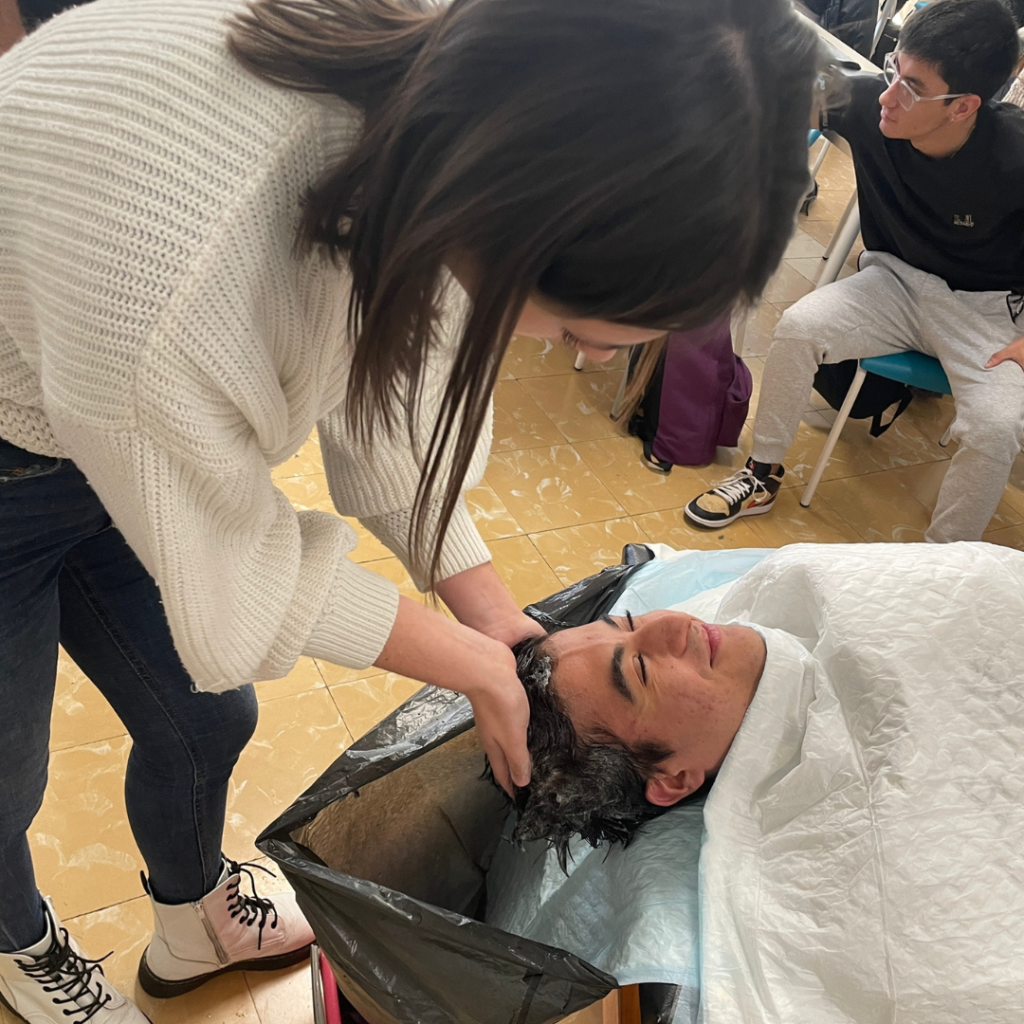 Alumnat de TAPSD practicant com rentar el cap a una persona que ho necessita